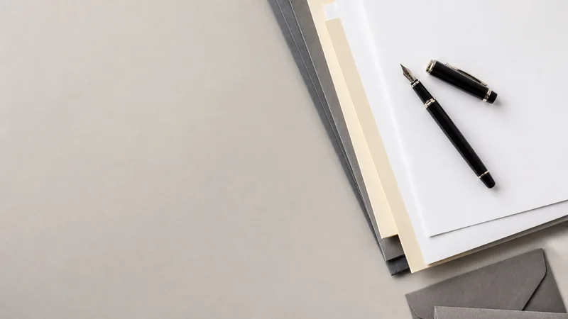 Styled flat-lay of closing documents and a fountain pen on a clean background, clean even studio light, generous negative space for overlaid text